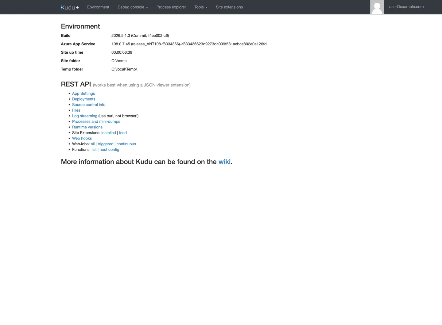 Kudu+ Environment home page. Top navigation lists Environment, Debug console (dropdown), Process explorer, Tools (dropdown), Site extensions, and a user@example.com (PII masked) account label. The Environment heading lists Build 2026.5.1.3 (Commit: f4ee002fc6), Azure App Service <ip-redacted> (release_ANT108-f8334366)+f833436623d9273dc099f581aebca802e0a126fd, Site up time 00.00:06:39, Site folder C:\home, Temp folder C:\local\Temp\. The REST API heading with caption "(works best when using a JSON viewer extension)" is followed by a list of items: App Settings, Deployments, Source control info, Files, Log streaming (use curl, not browser!), Processes and mini-dumps, Runtime versions, Site Extensions (installed | feed), Web hooks, WebJobs (all | triggered | continuous), Functions (list | host config). The footer states "More information about Kudu can be found on the wiki."