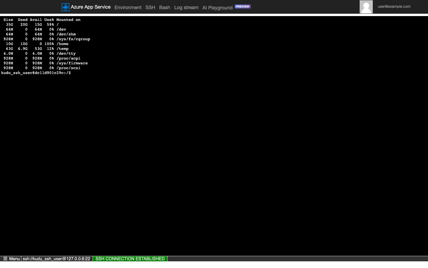 Kudu SCM Diagnostic Console for Web App app-labdisk-uz2rvn6exc56q showing an SSH terminal session. Top navigation bar reads Azure App Service with tabs Environment, SSH, Bash (active), Log stream, AI Playground Preview, and account label user@example.com on the right. Terminal displays the tabular output of `df -h --output=size,used,avail,pcent,target` (Filesystem column intentionally omitted for PII safety) with 10 mount rows: overlay root at 35G/20G/15G 59% /, tmpfs /dev at 64M/0/64M 0%, shm /dev/shm at 64M/0/64M 0%, tmpfs /sys/fs/cgroup at 928M/0/928M 0%, SMB share /home at 10G/10G/0 100%, /dev/sda3 /temp at 63G/6.9G/53G 12%, devtmpfs /dev/tty at 4.0M/0/4.0M 0%, tmpfs /proc/acpi at 928M/0/928M 0%, tmpfs /sys/firmware at 928M/0/928M 0%, tmpfs /proc/scsi at 928M/0/928M 0%. The /home row shows 100% Use%, contrasted with 0-59% on the other 9 mounts. Bottom status bar reads "SSH CONNECTION ESTABLISHED" with a green background. Shell prompt shows kudu_ssh_user followed by a short 12-character container hostname, then :/$. No source-device paths or SMB mount paths are shown because the Filesystem column is excluded; only the mounted-on targets remain visible.